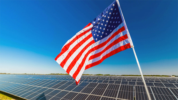 Solar panels behind the American Flag