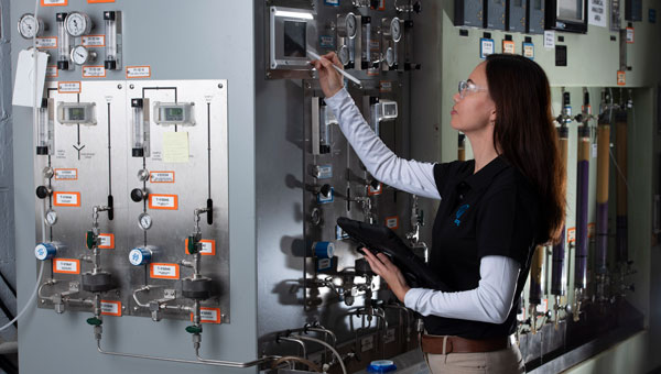 A woman checking machinery A woman checking machinery