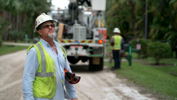 FPL Crew wearing lime green vests and restoring power