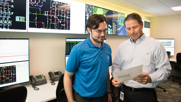 two-male-employees-reviewing-list