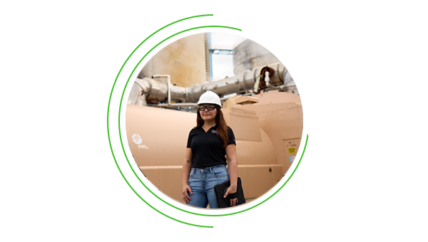 NextEra Energy engineer posing in front of a natural gas plant.