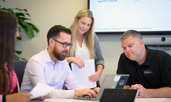 NextEra Energy team members collaborating in a conference room meeting.