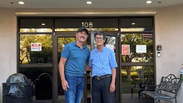 Miguel Santiago (left) poses with Vietnamese student he tutored at El Sol. 