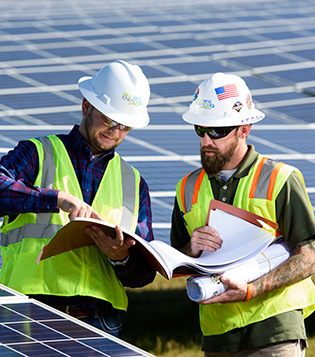 Two FPL employees working at a solar field