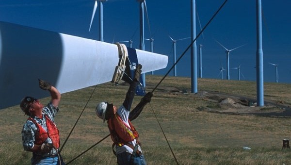 Workers assembling wind turbines