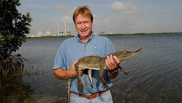 University of Florida biologist holding a baby crocodile