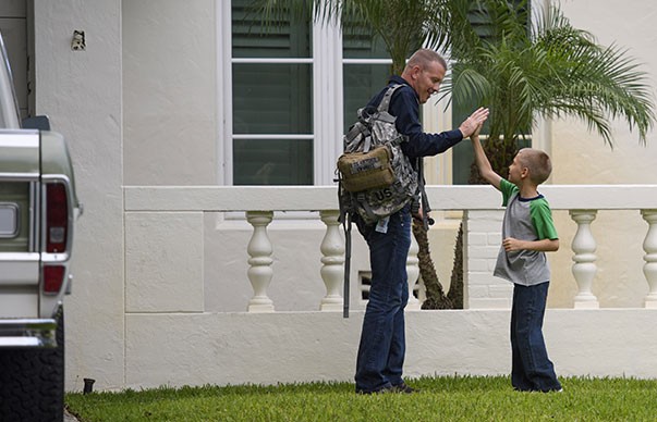 A man and a boy doing a high five