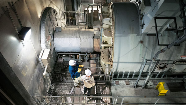 Engineers inspecting heavy equipment inside an nuclear power plant..